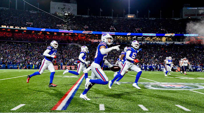 Buffalo Bills safety Micah Hyde, center, celebrates after catching an interception during the first half of an NFL wild-card playoff football game against the New England Patriots, Saturday, Jan. 15, 2022, in Orchard Park, N.Y.